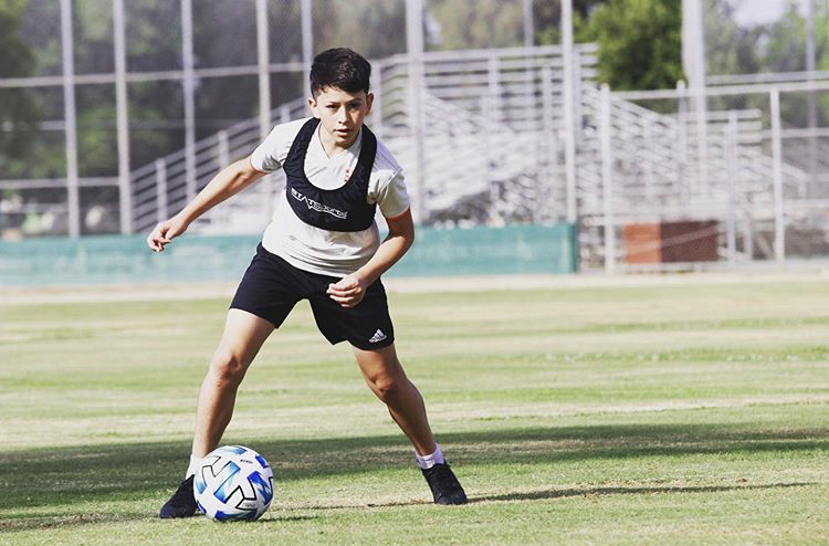 Youth Football Player Running with Parachute. Soccer Football